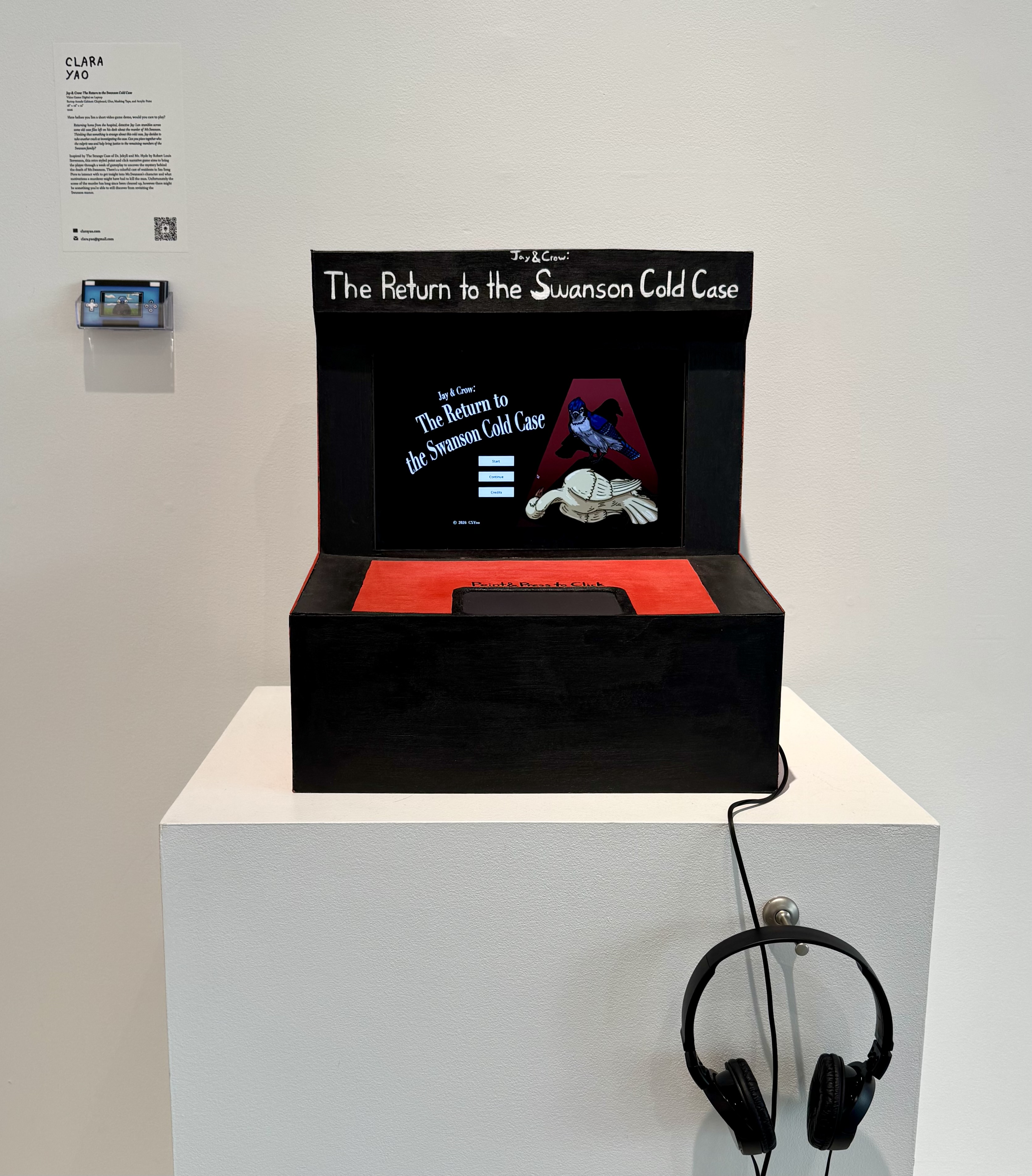 An image of Jay and Crow: The Return to the Swanson Cold Case (2026) at the Parsons BFA Illustration Class of 2026 Senior Show. The game is displayed on a laptop housed in a bartop arcade cabinet facade.