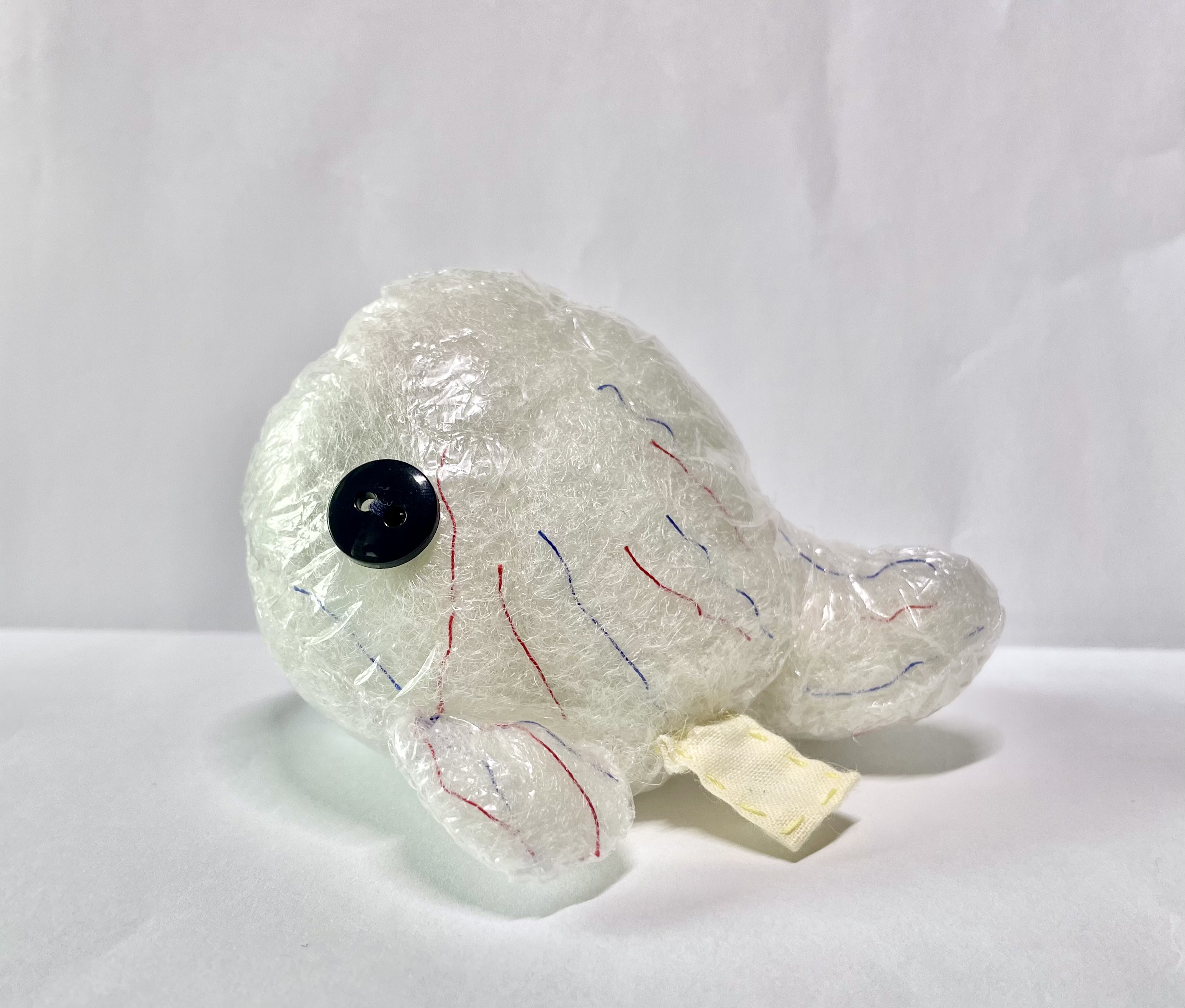 A custom Heart Whale made out of plastic to give it a transparent skin. Threads of red and blue are introduced into the stuffing in order to look like veins.