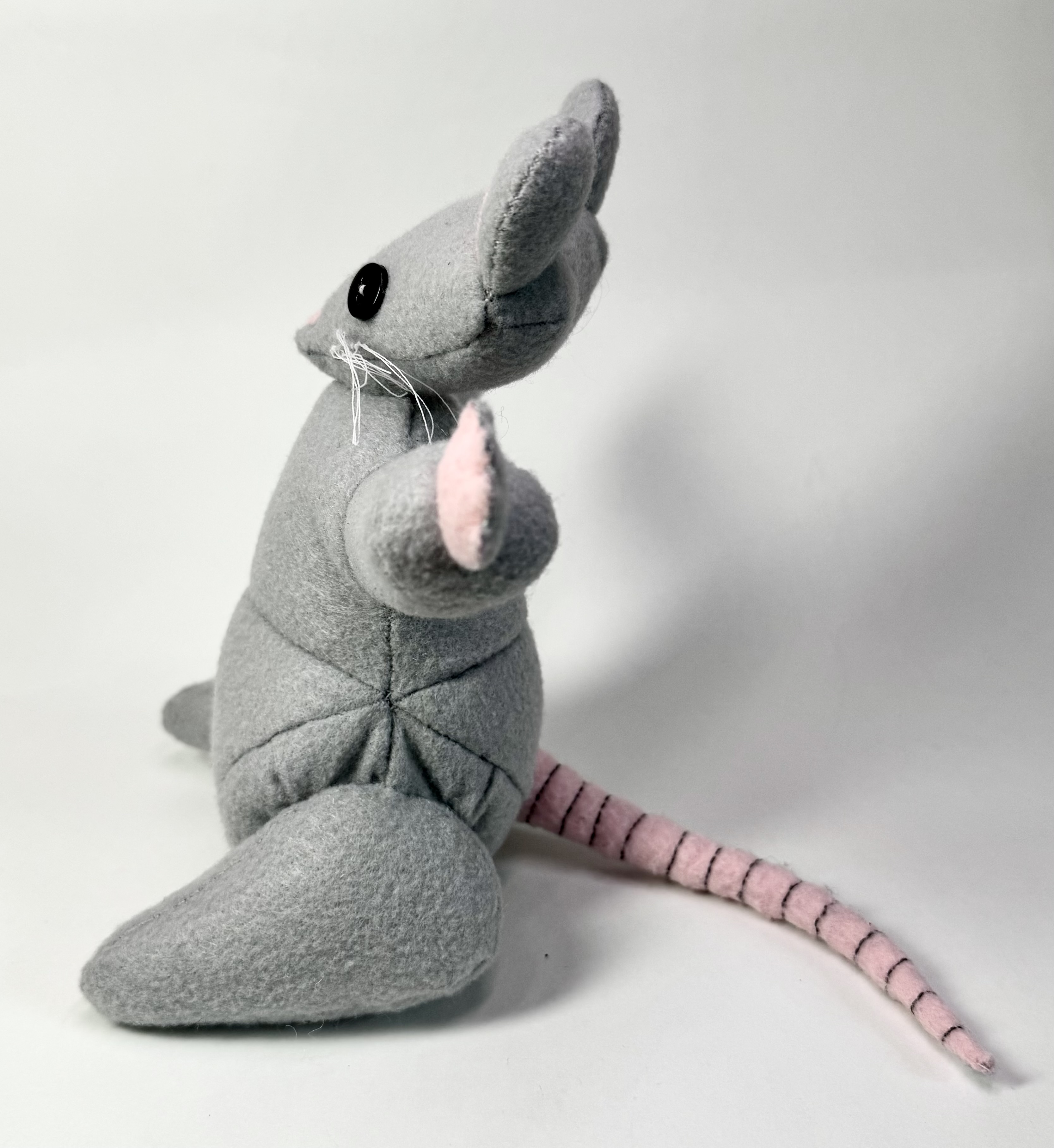 Left view of the Riggs the Rat stuffed animal